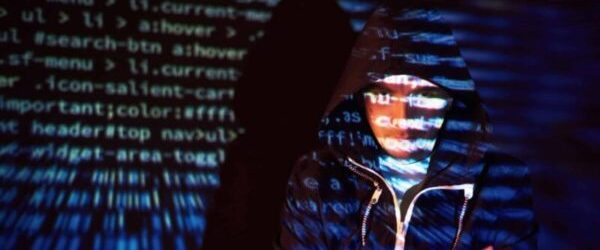 Cyber attack with unrecognizable hooded hacker using virtual reality, digital glitch effect.